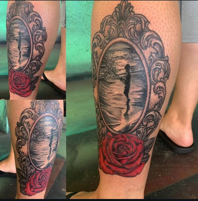 Heather Baldwin realism fishing silhouette tattoo with rose on calf, Hawaii